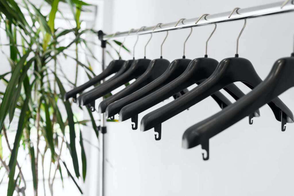 Plastic empty clothes hangers on rack